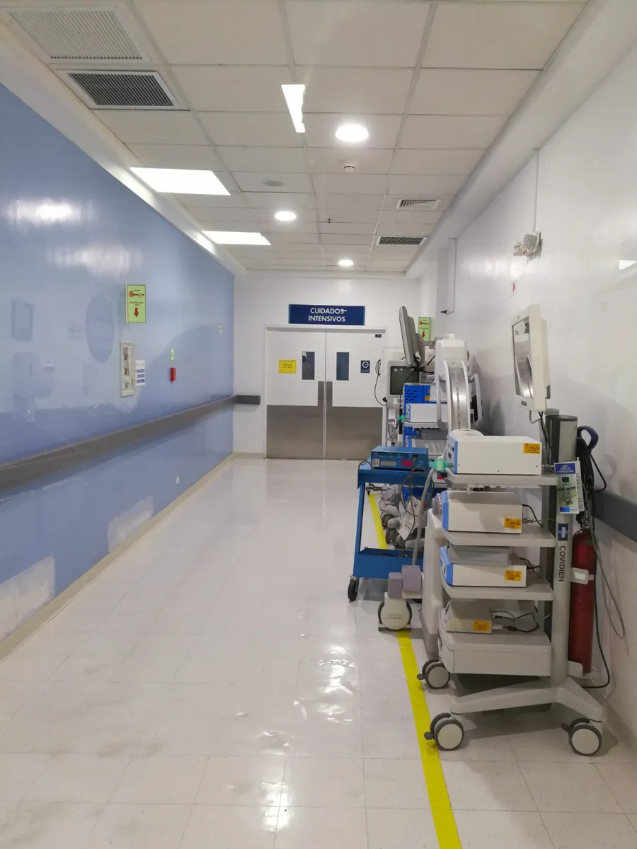 Pasillo de área hospitalaria con iluminación y tomas de circuitos esenciales